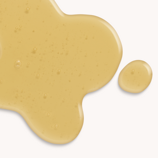 A drop of meadowfoam oil lays on a clean surface